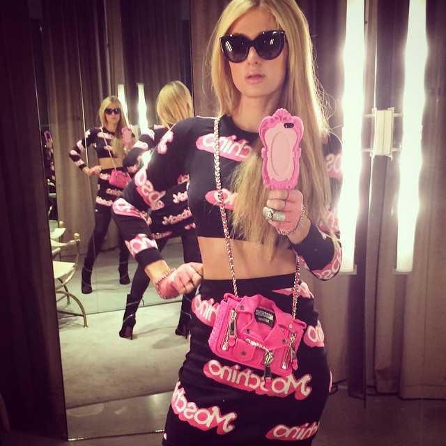 Paris Hilton in baby pink Moschino dress and bag at Art Basel event