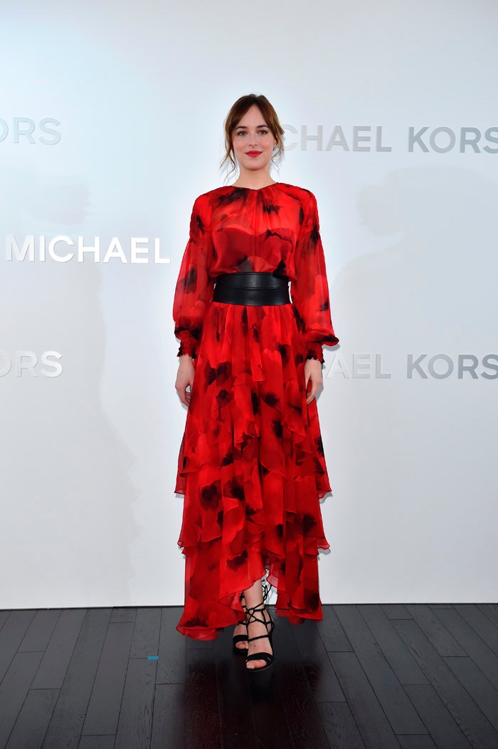NOVEMBER 2015 - Dakota Johnson at Michael Kors Ginza store opening in Japan wearing red poppy print dress. Photo: Michael Kors / Getty Images