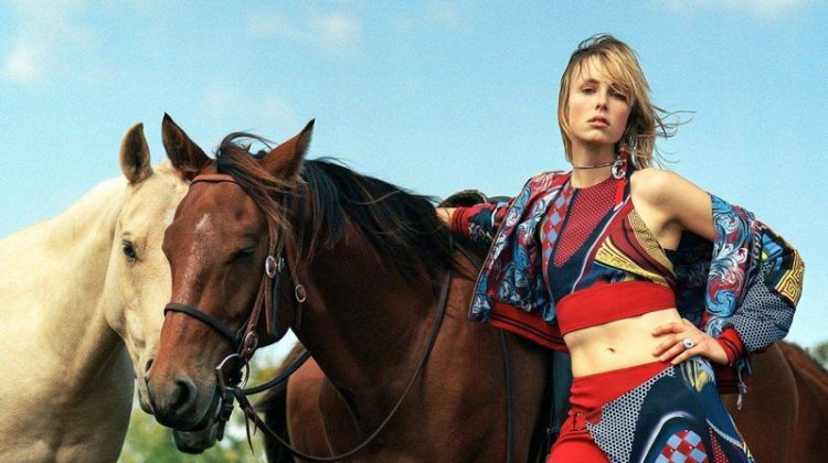 Model Edie Campbell poses next to a horse in Versace's spring 2017 campaign