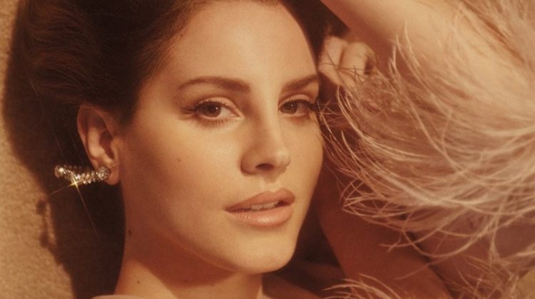 Looking ultra-glam, Lana Del Rey poses in Prada chiffon and ostrich feather dress with Gillian Horsup earrings
