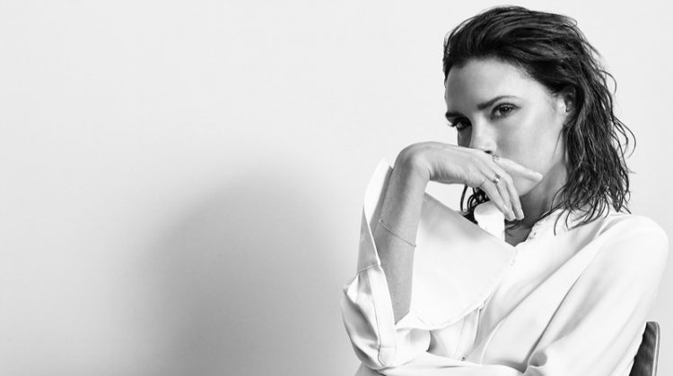Victoria Beckham poses in button-up blouse, adidas track pants and sneakers