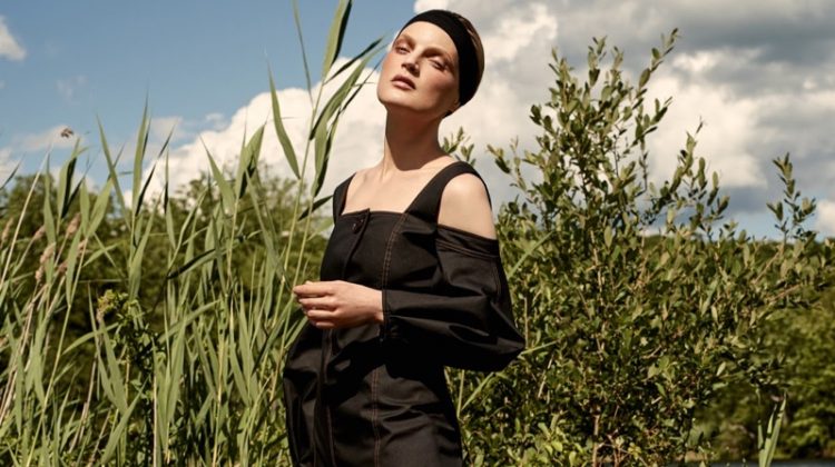 Model Guinevere van Seenus poses in Ellery cold-shoulder dress and The Row leather sandals