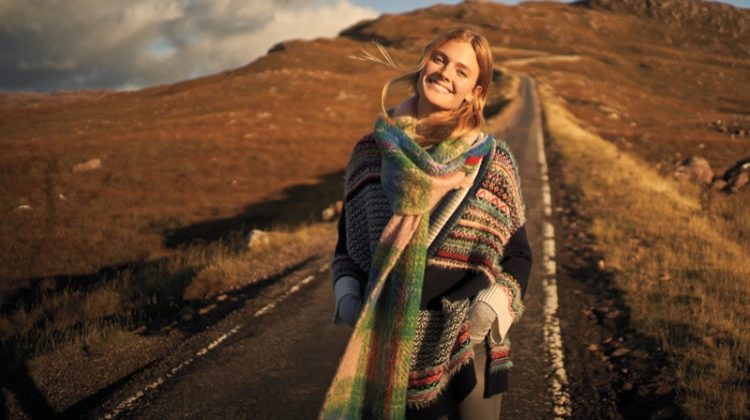 Model Constance Jablonski layers up in knit scarf and striped sweater for Anthropologie’s November 2017 catalog