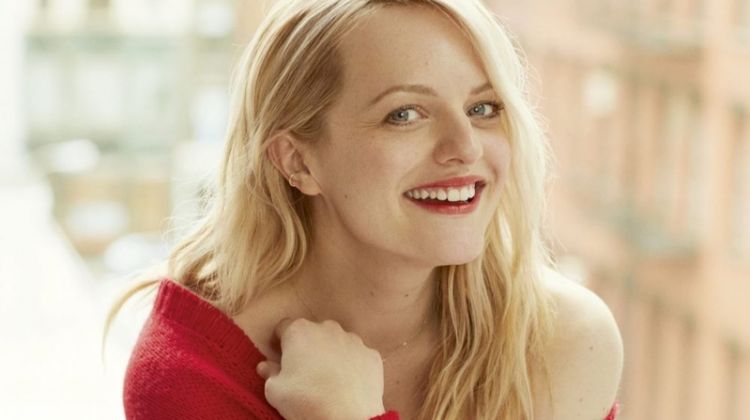 Actress Elisabeth Moss poses in red Dior sweater