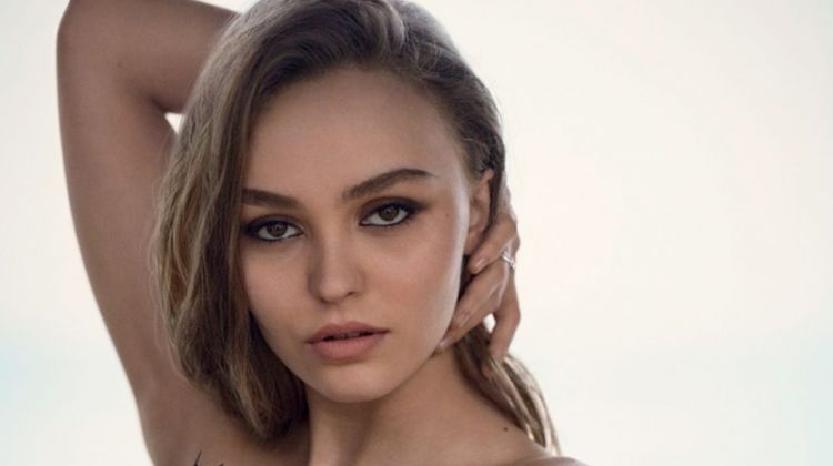 Actress Lily-Rose Depp poses in feather embellished dress from Chanel