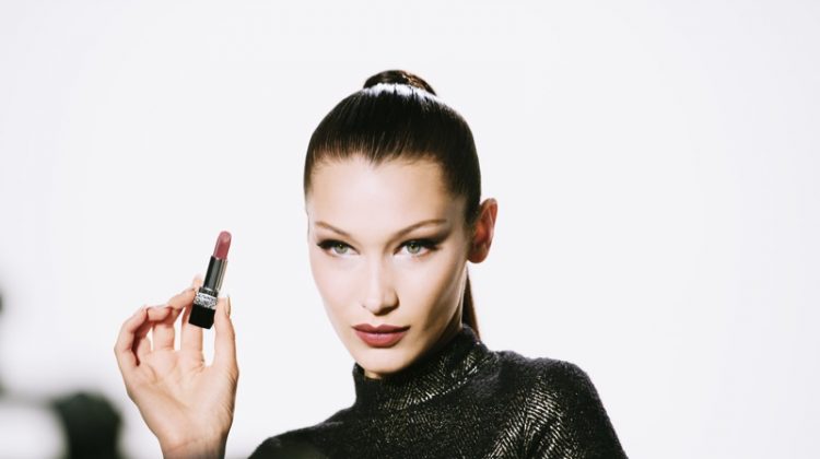 Wearing a sleek ponytail, Bella Hadid poses on set of Rouge Dior Wishes campaign