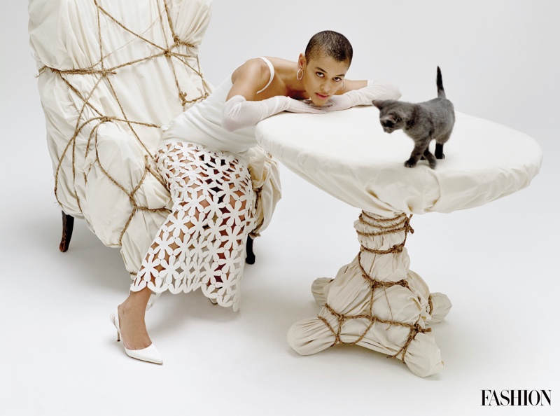 Gossip Girl star Jordan Alexander wears a Valentino dress while posing with a cat.