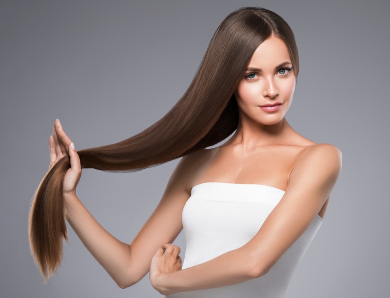 Brown Haired Model Holding Long Straight Hair