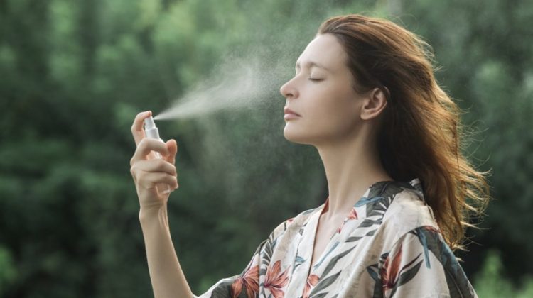 Woman Applying Face Mist Skin