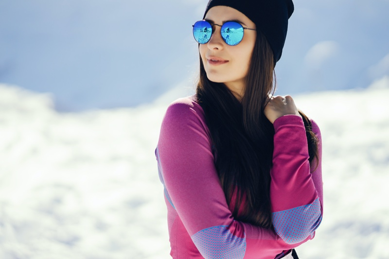 https://www.fashiongonerogue.com/wp-content/uploads/2021/12/Woman-Pink-Top-Snow-Blue-Sunglasses.jpg