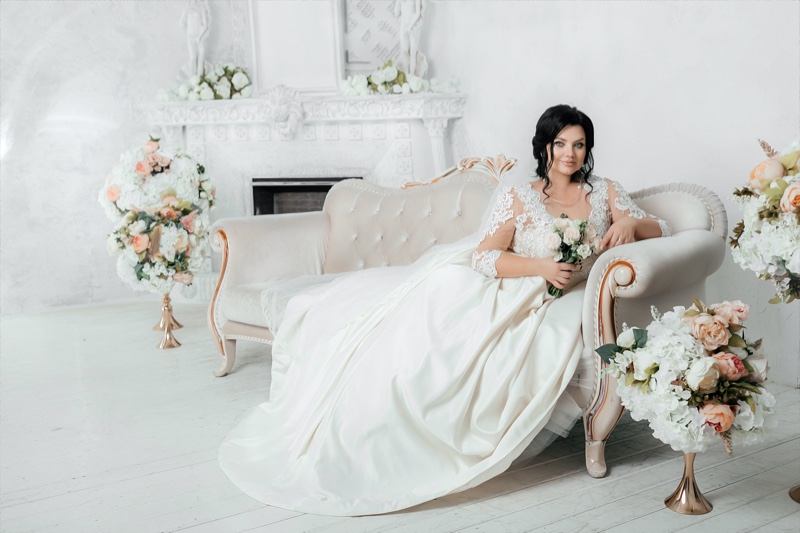 https://www.fashiongonerogue.com/wp-content/uploads/2022/03/Plus-Size-Bride-Sitting-Wedding-Dress.jpg