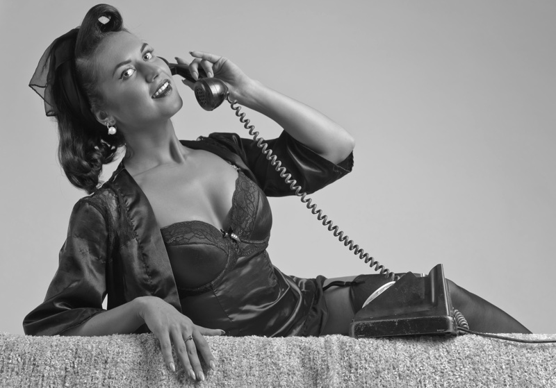 https://www.fashiongonerogue.com/wp-content/uploads/2022/04/Vintage-Lingerie-1950s-Inspired-Woman-Phone.jpg