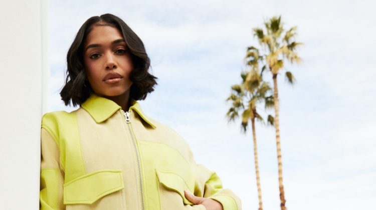 Model Lori Harvey poses in acid green styles for Kith Women spring 2023 campaign.