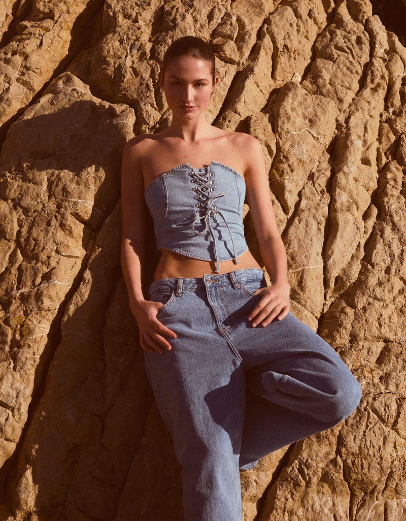 Angelina Frerk models a Bershka denim look, featuring a lace-up denim top and relaxed jeans.