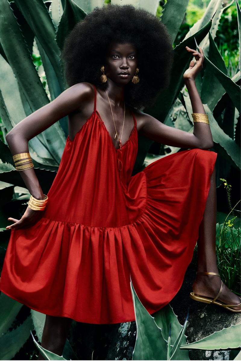 Looking stunning in a red maxi dress, Anok Yai fronts the H&M summer 2024 campaign.