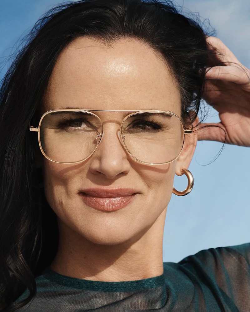 Wearing oversized frames, Juliette Lewis poses in Warby Parker Sade Glasses in Polished Gold.