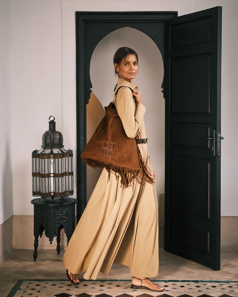 Posing in Marrakech, Liya Kebede models the fringe-adorned Poncho bag from CH Carolina Herrera.