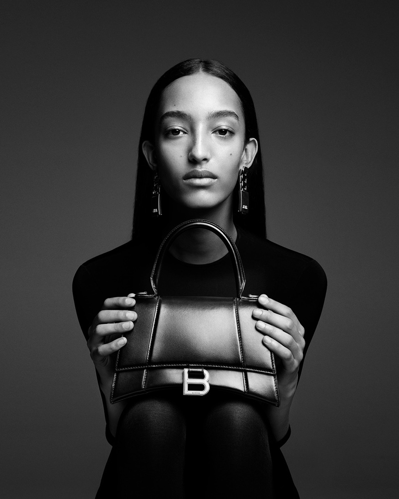 Model Mona Tougaard holds the Balenciaga Hourglass bag for 2024 campaign.