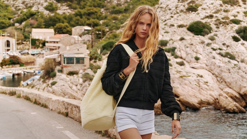 Keeping it casual in a zip-up jacket and shorts, Olivia Vinten fronts Chanel Coco Beach 2024 ad.