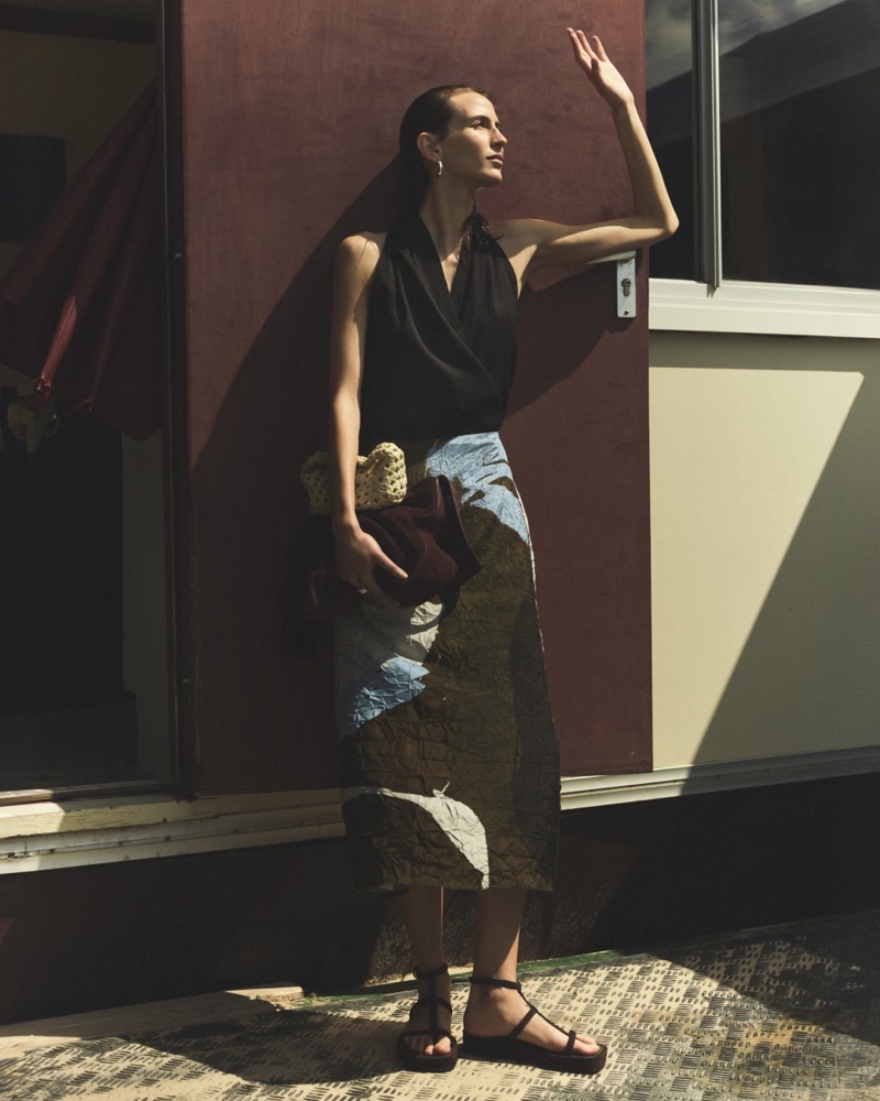 Massimo Dutti spotlight a linen blend halter top and printed midi skirt for its Minimal Resort editorial.