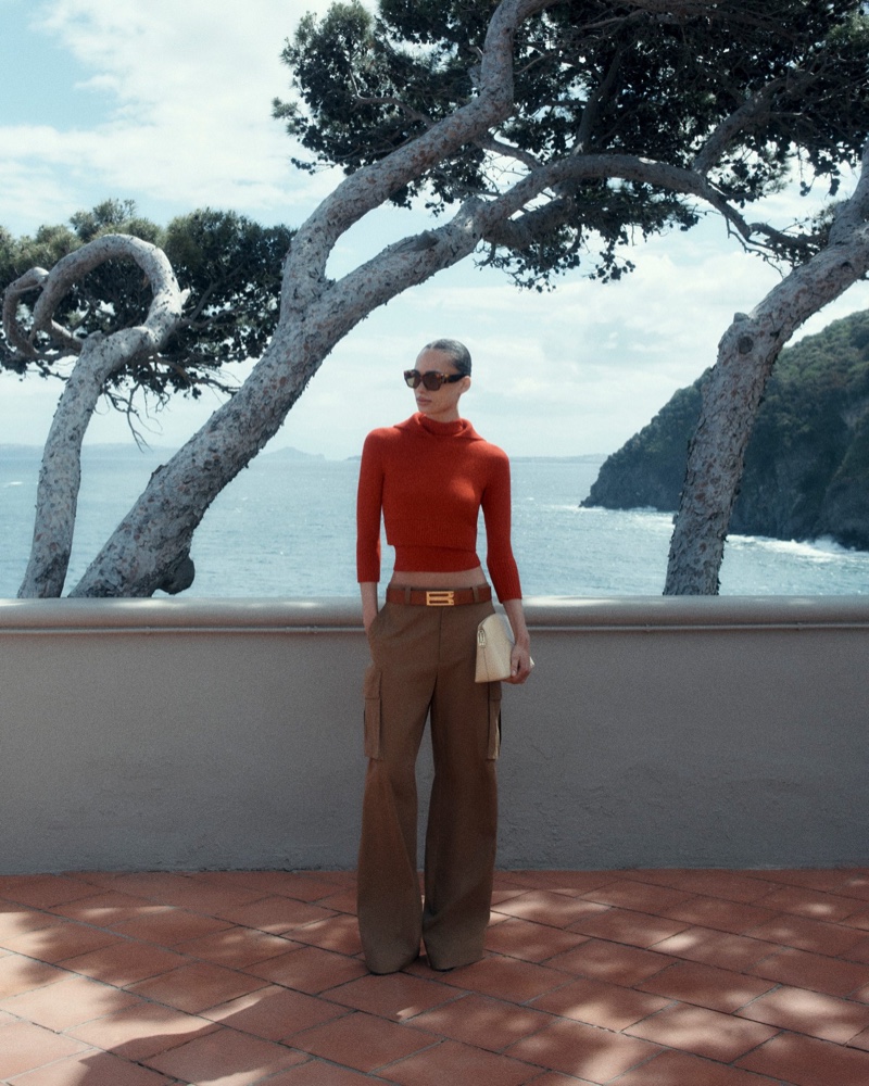 Keeping it casual chic, Victoria Beckham offers a cropped sweater and cargo pants for high summer 2024.