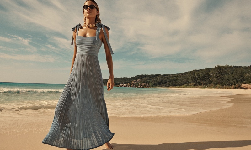Zimmermann features the Waverly dress in metallic blue from its summer swim 2024 collection.