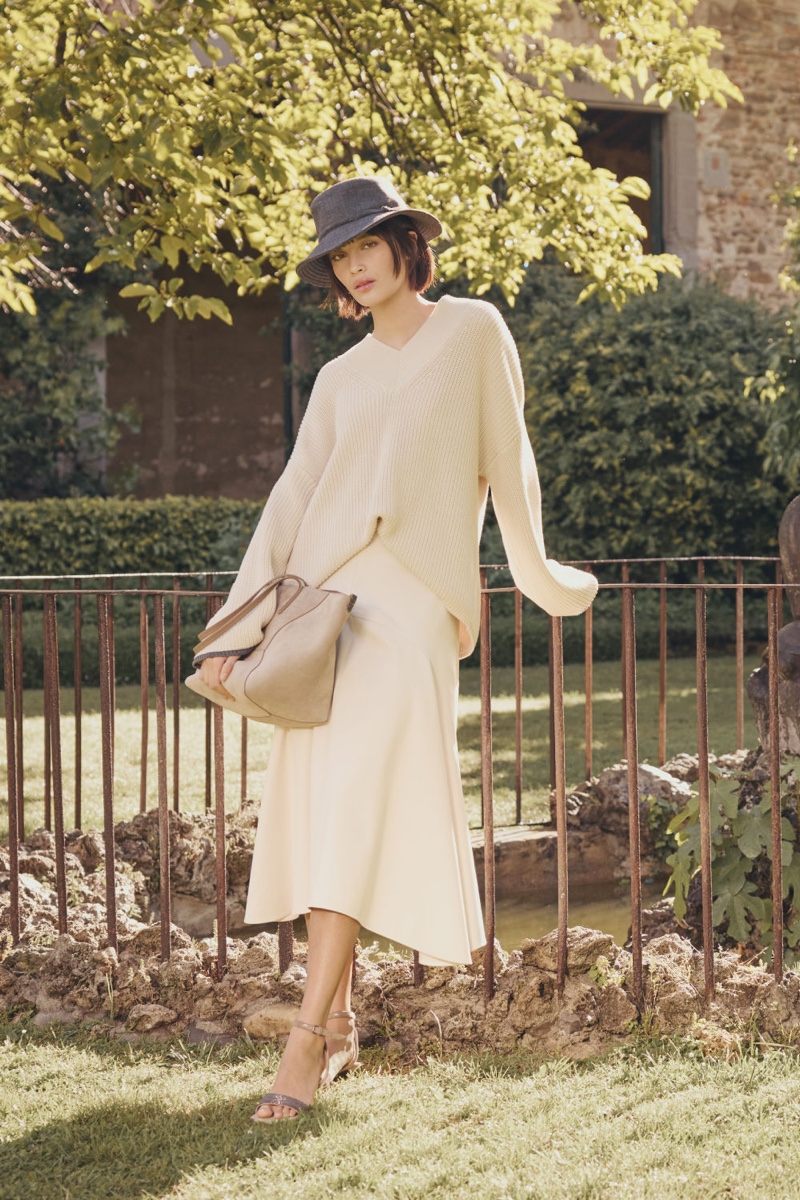 Showcasing a relaxed style, Brunello Cucinelli's fall 2024 collection includes a cozy knit sweater and flowy skirt.