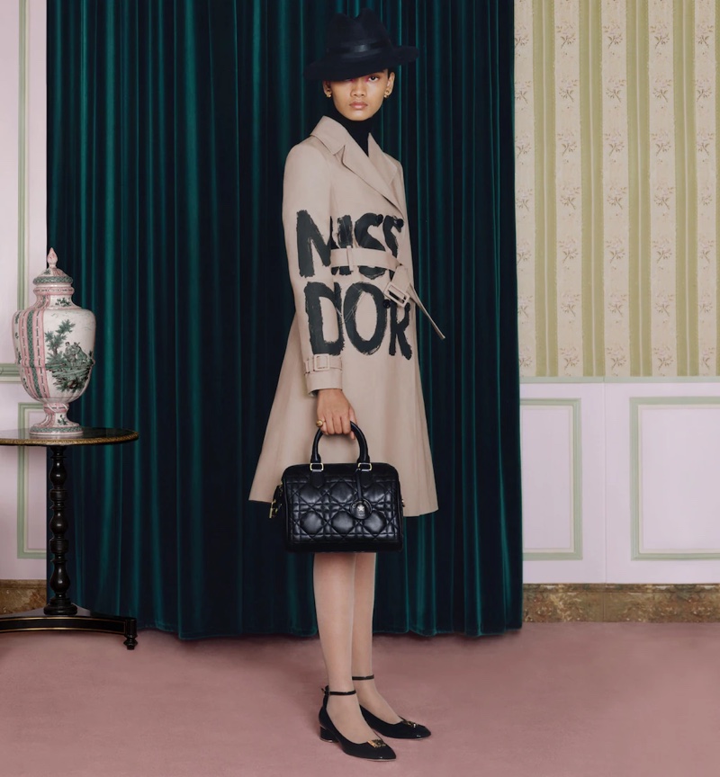 The Miss Dior graffiti print decorates a tailored trench coat for fall 2024.