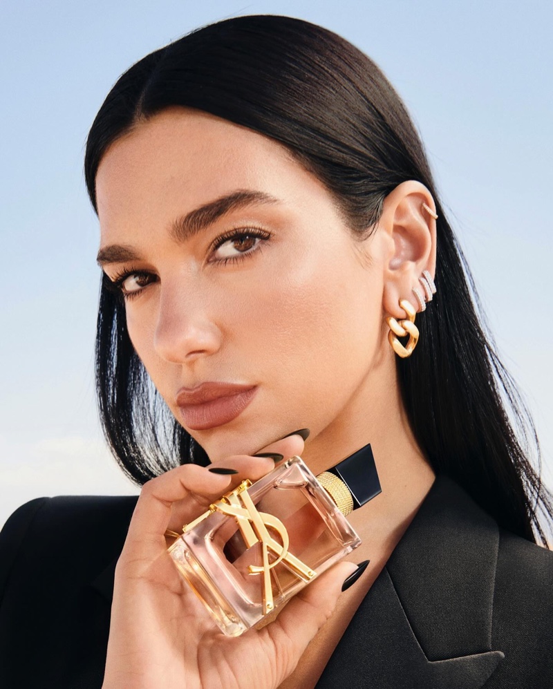 YSL Beauty ambassador Dua Lipa poses with the new Libre Flowers & Flames Eau de Parfum bottle.