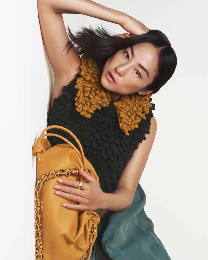 Posing with the Flamenco bag, Greta Lee fronts Loewe's fall 2024 ad.