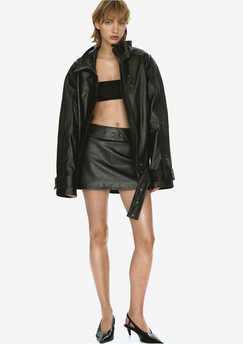 Featuring all-black, H&M Studio highlights a boxy leather jacket with a leather mini skirt for pre-fall 2024.