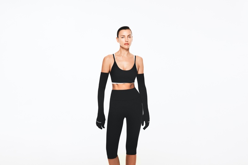 Rocking gloves, Irina Shayk shows H&M Move's sports bra and leggings look.