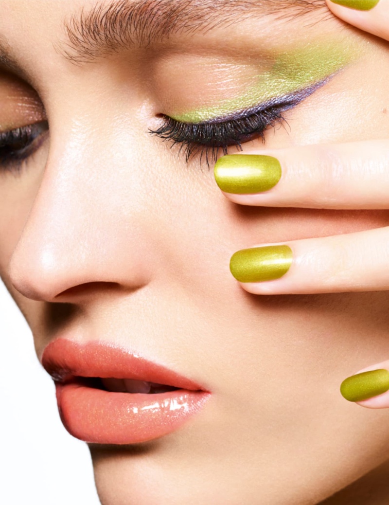 Lily-Rose Depp matches her green eyeshadow with neon nail polish for Chanel Makeup's summer 2024 collection.