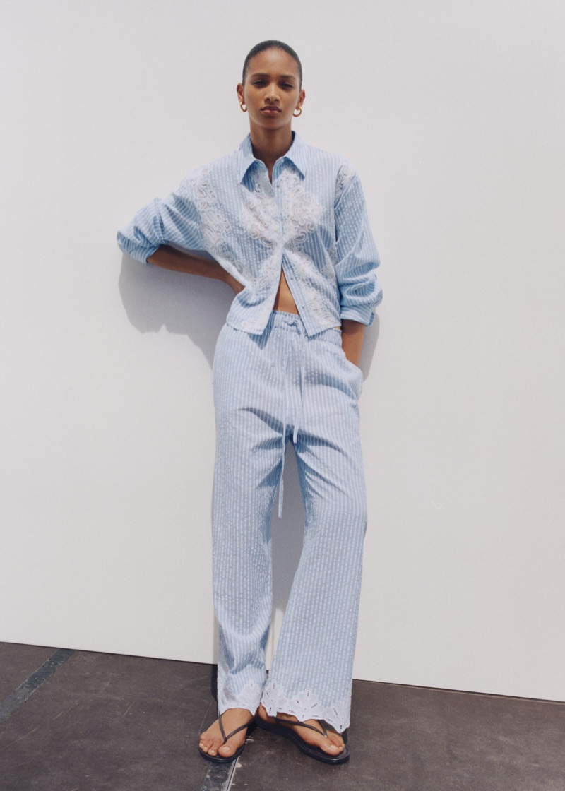 Elodie Guipaud shows off Mango's summer embroidered striped shirt and trousers with stripes.