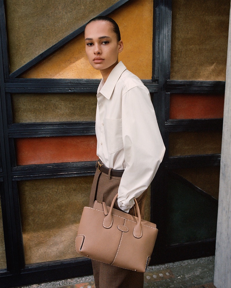 Annemary Aderibigbe poses in a neutral ensemble for Tod's pre-fall 2024 ad.