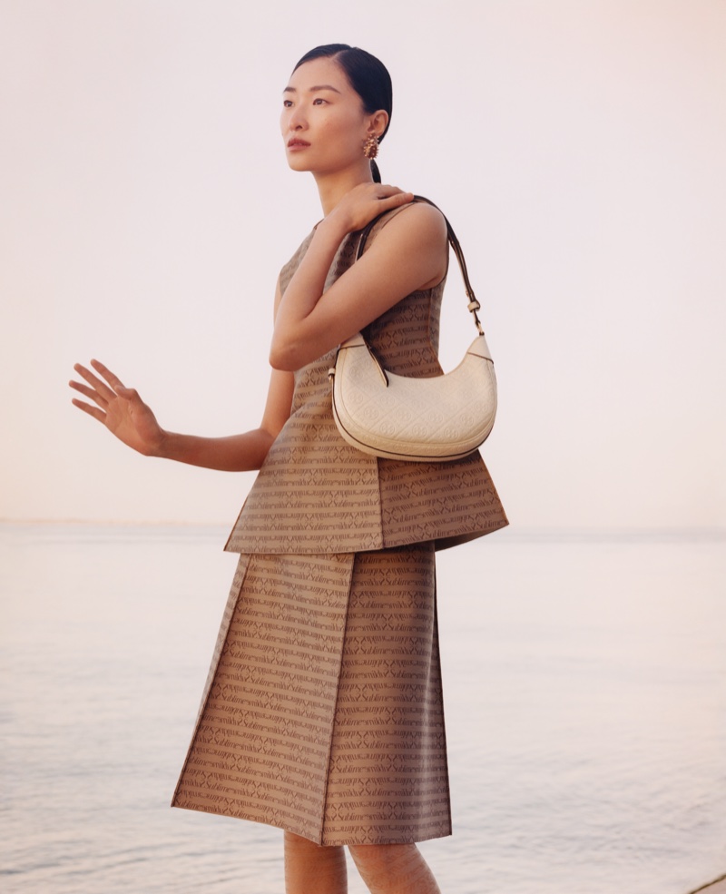 Chu Wong shows off the T Monogram Crescent bag from Tory Burch's fall 2024 collection.