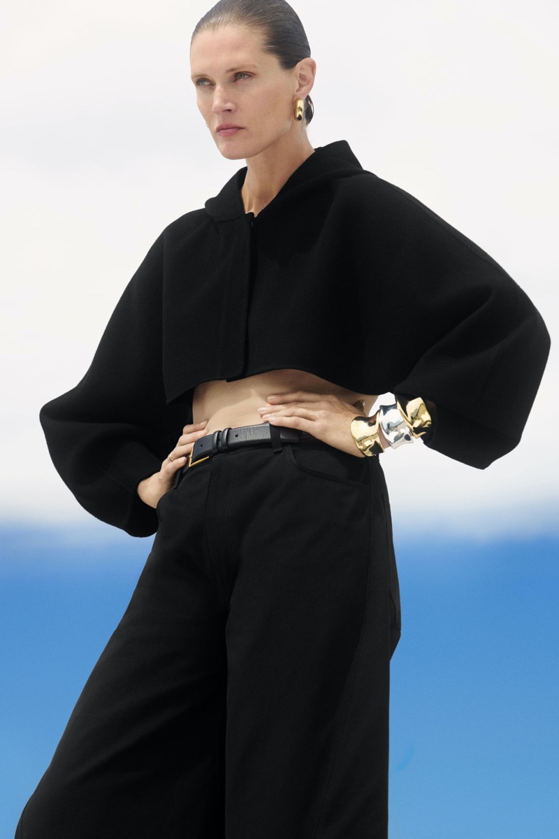 Modeling all-black, Malgosia Bela wear a cropped hoodie and trousers look.