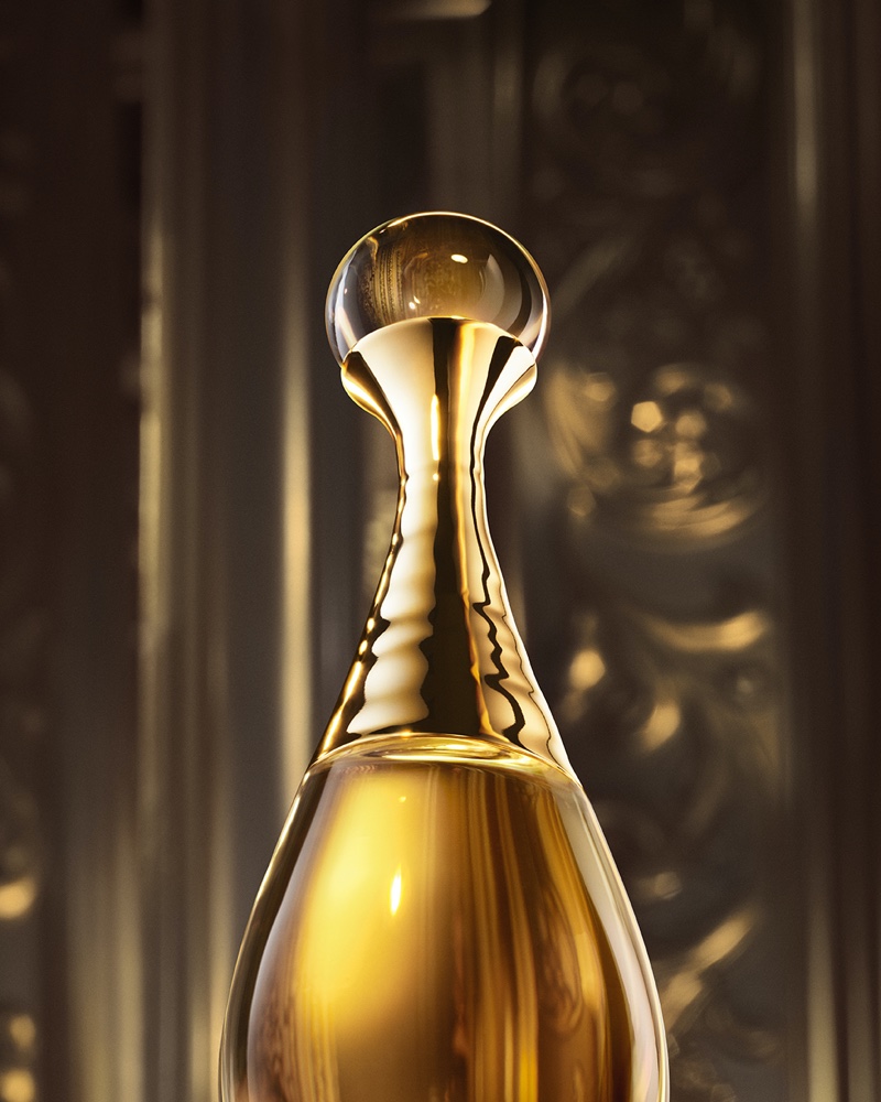 A look at Dior's J'adore l'Or fragrance bottle featuring a metallic gold necklace.