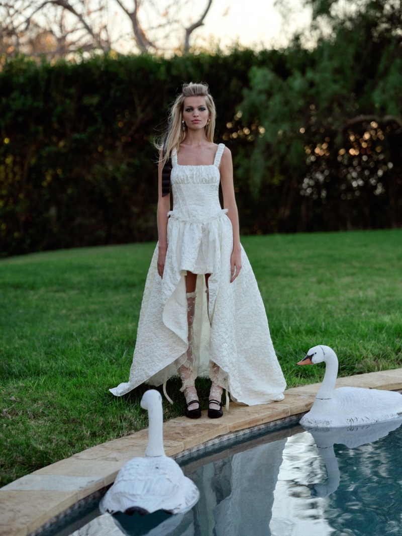 Daphne Groeneveld models For Love & Lemons Bridal's Claire wedding gown.