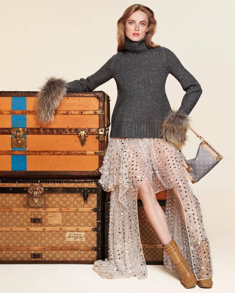 Rianne van Rompaey layers up in a sweater, embellished skirt, and leather boots.