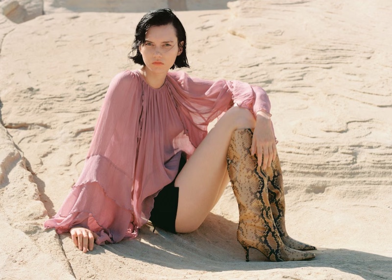 Steinberg poses in a Mango ruffled chiffon blouse and lace-up shorts.