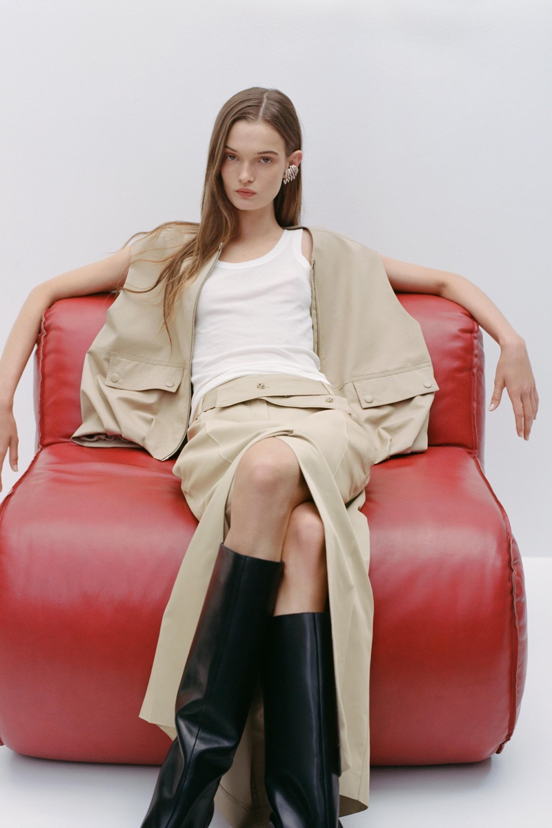 Lulu Tenney models Zara oversized vest, linen blend tank top, gabardine skirt, and wide shaft leather boots.