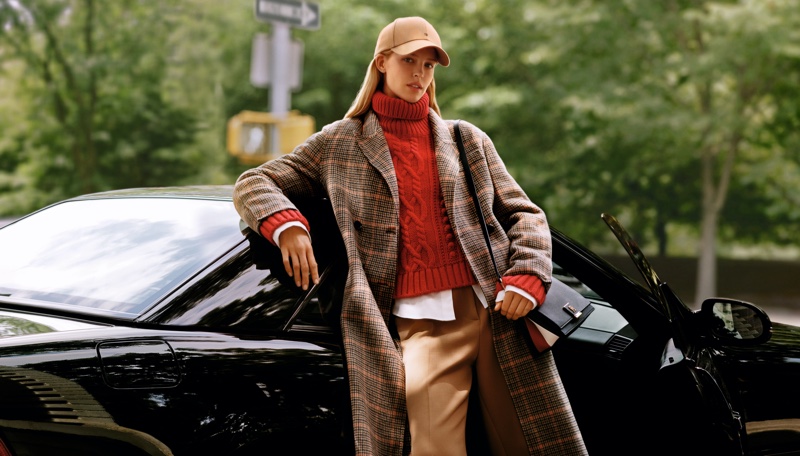 Posing in New York City, Abby Champion wears a plaid jacket and cableknit sweater for Tommy Hilfiger's fall 2024 ad.