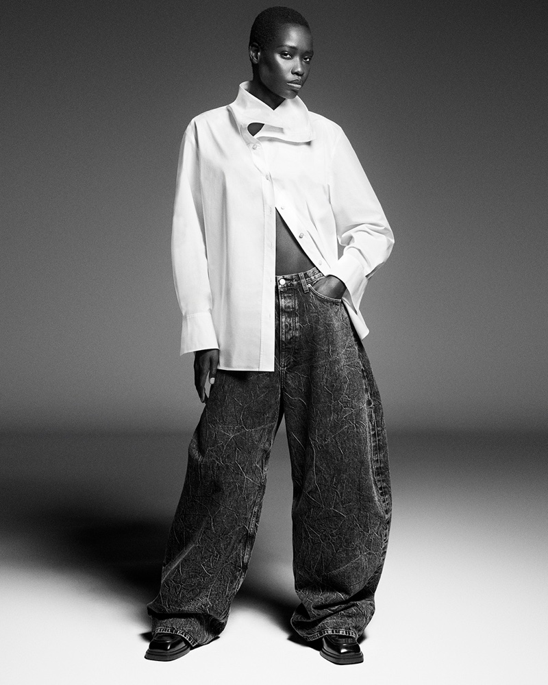 Awar Odhiang models a shirt and baggy jeans for COS' fall-winter 2024 campaign.