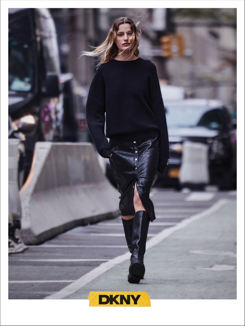 DKNY features an all-black ensemble for fall 2024 with sweater and skirt designs.