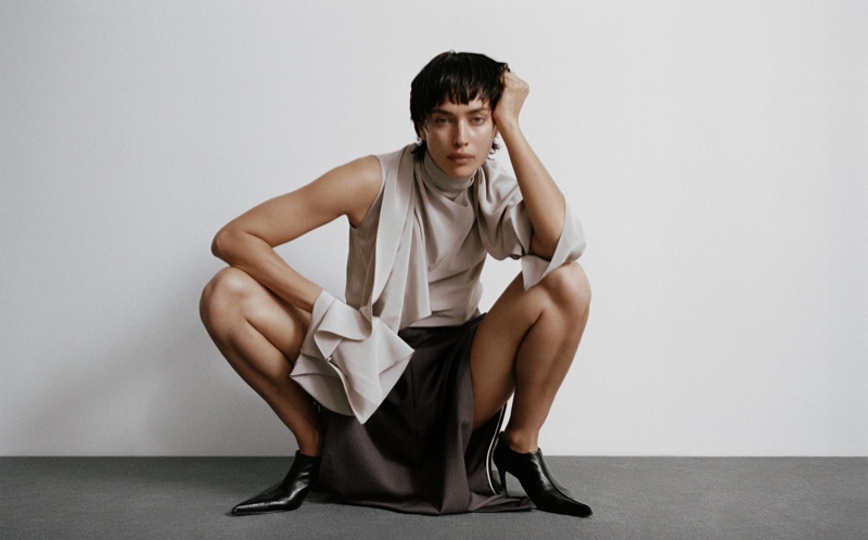 Irina Shayk crouches down in utilitarian-inspired separates for Helmut Lang's fall 2024 campaign.