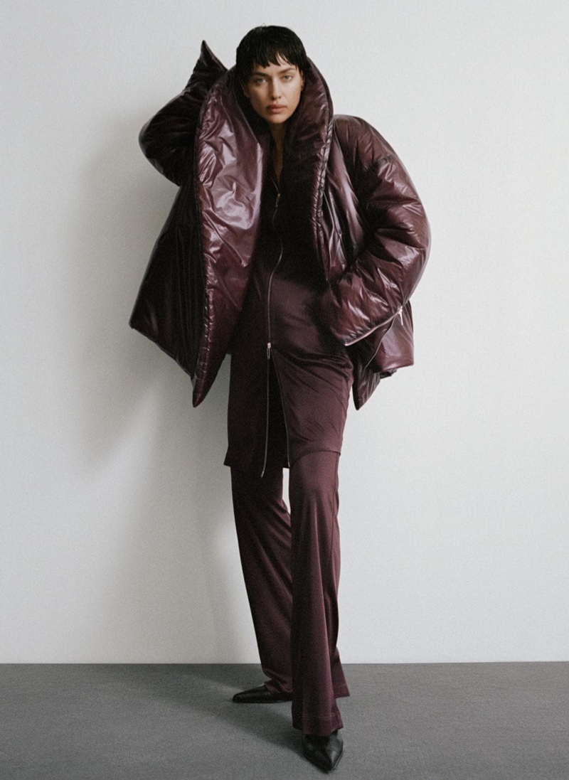 Layering up, Irina Shayk models Helmut Lang's cocoon puffer jacket and car trousers for fall 2024.