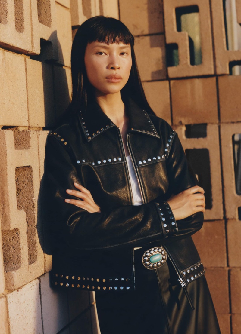 Mango channels cowgirl vibes with a studded leather jacket and midi skirt paired with a buckle leather belt.