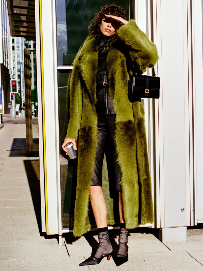 Mica Argañaraz models a green faux fur coat from Mango Selection's fall 2024 collection.