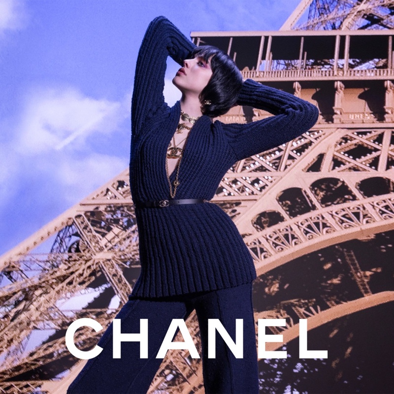 Posing next to the Eiffel Tower, Margaret Qualley wears a knit top for Chanel's fall 2024 ad.